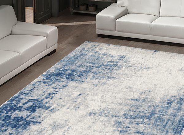 A BEAU COSY blue and white rug beautifying a living room.