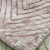 A pink BELMONT rug, ideal for adding a pop of color to any room.